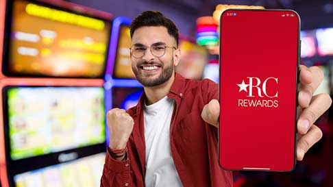 happy man holding out red carpet reward app on mobile phone