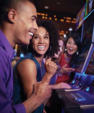 four people playing slots